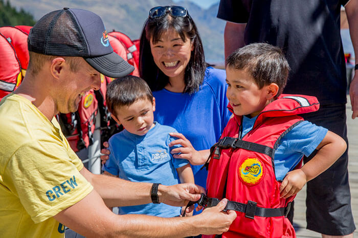 Family getting life jackets on before jet boating in Queenstown New Zealand