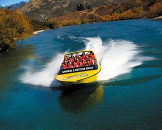 Jet boating with KJet Queenstown along the green Kawarau River in autumn