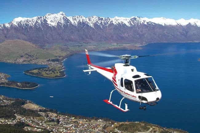 Helicopter flying above Lake Wakatipu with the Remarkables mountain range in the background