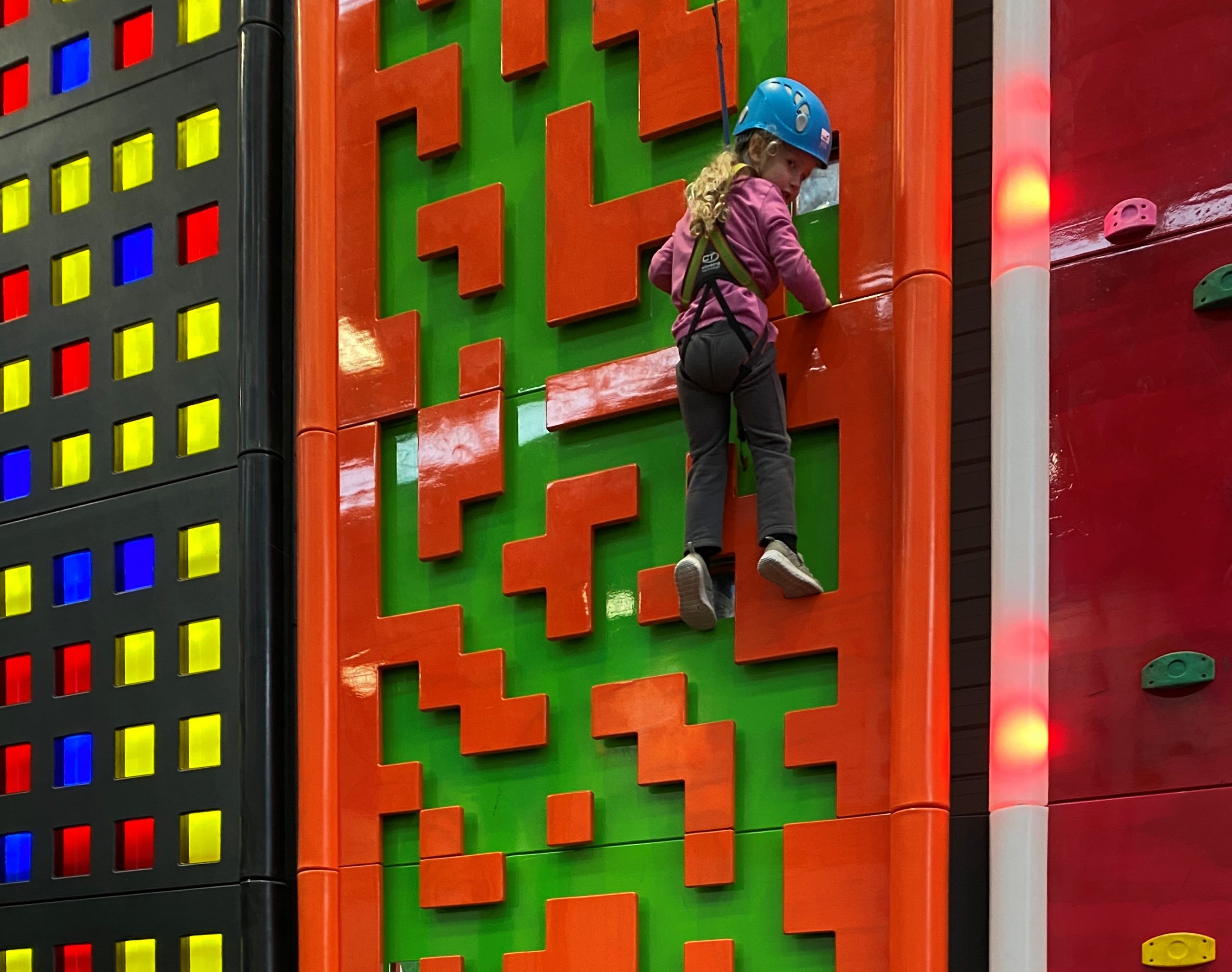 Child enjoying climbing wall at Clip n Climb Queenstown